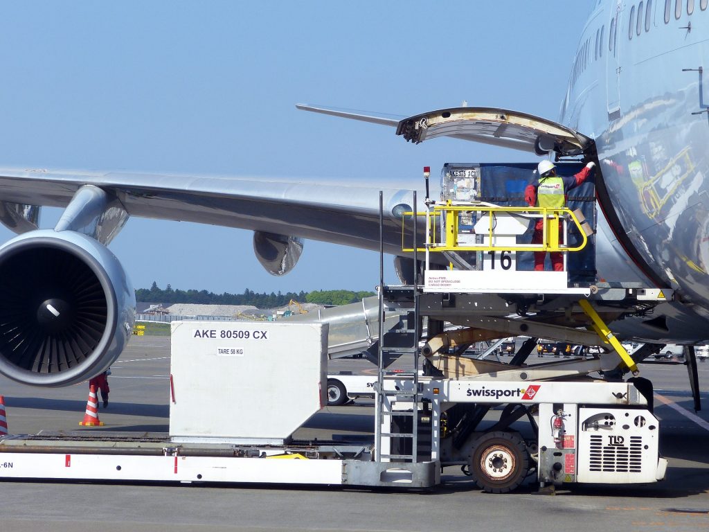 a ULD containing air freight behind loaded on the lower deck of an airplane
