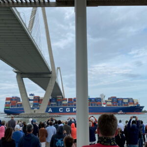 Crowd gathers to see the Very Large Container Ship - CMA CGM Brazil - approach the port of Charleston on its record breaking journey.