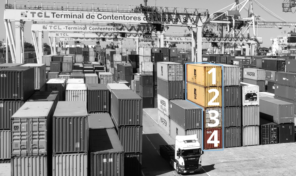 A container stack used to illustrate our container tack logistics glossary item. Shows 4 containers loaded on top of each other with the highest 2 ready to leave on an earlier sailing than the lower 2.