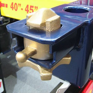 A close up photo of a twist lock installed on a container chassis - this twist lock will be inserted into a corner of container and then turned to secure / lock the container in place